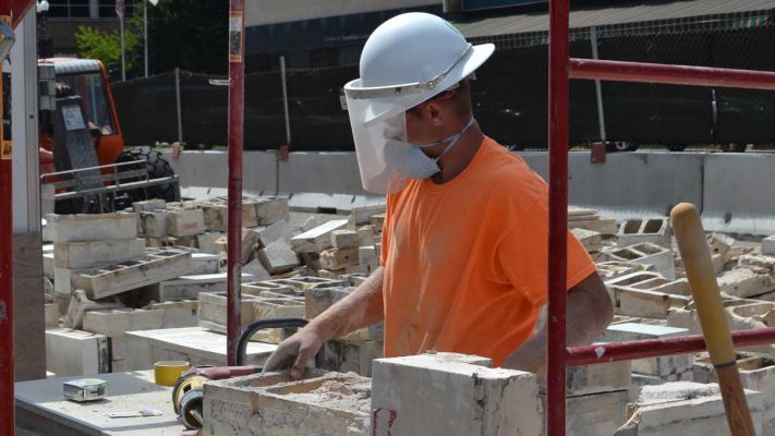 Building Construction Worker Cutting Concrete